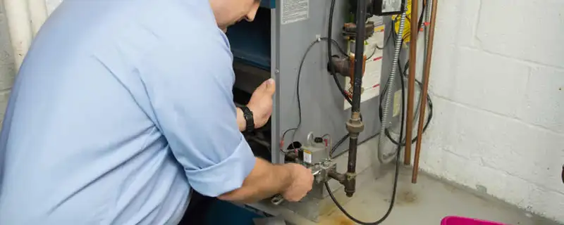Furnace repair technician inspecting and servicing a home heating system in San Jose, CA