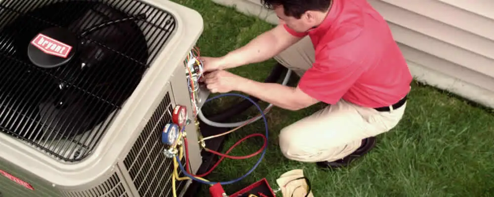 HVAC technician servicing an outdoor air conditioner unit in San Jose, CA