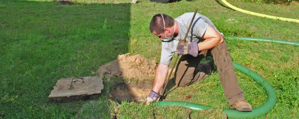 Septic pumping technician servicing a residential septic tank in San Jose, CA