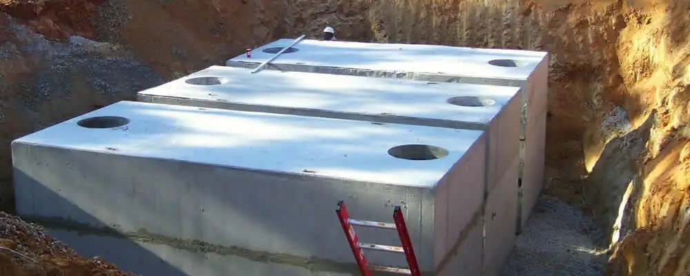 Septic tank installation site with a newly placed concrete tank in San Jose, CA
